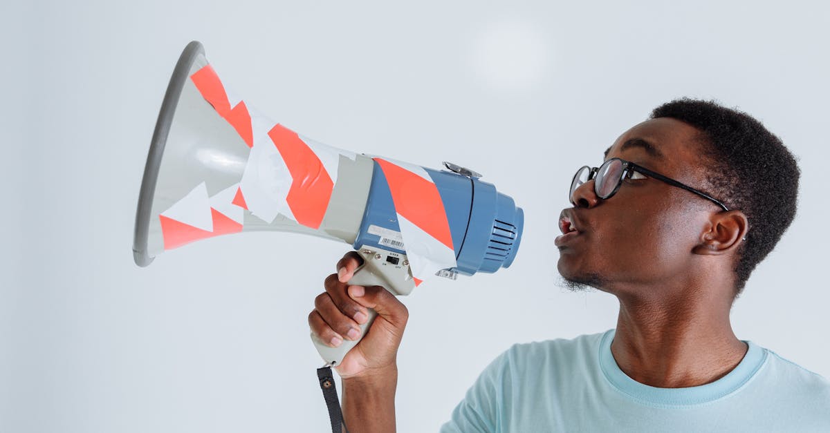 A Man in Blue Shirt Holding a Megaphone