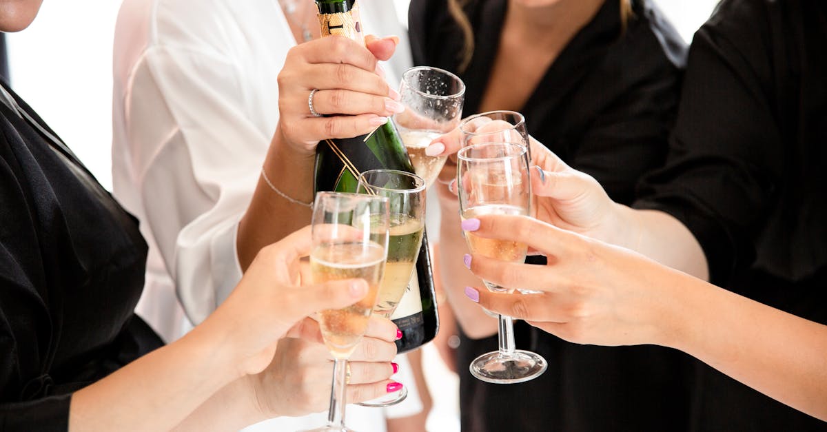 Women Celebrating and Holding Wineglasses and Champagne